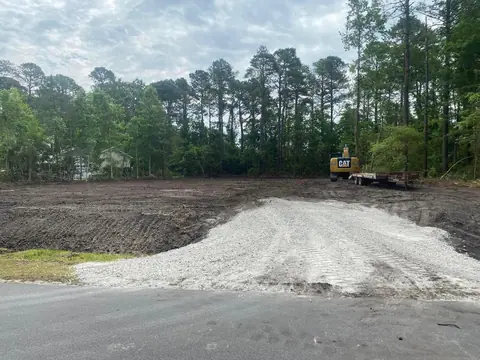 Stone stockpiled on a finished pad at the road — Coastal Clearing & Debris, Brunswick County NC