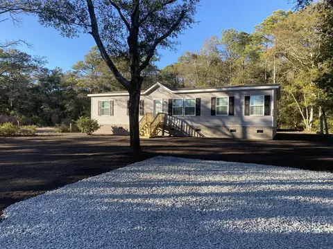 Finished stone drive under a mature oak — Coastal Clearing & Debris, Brunswick County NC